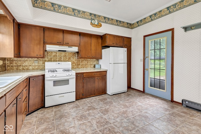 1437 S 725 W, Tipton, IN 46072 - kitchen with white appliances, under cabinet range hood, light countertops, backsplash, and crown molding