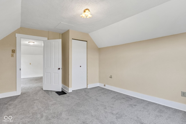 1437 S 725 W, Tipton, IN 46072 - additional living space featuring vaulted ceiling, carpet flooring, baseboards, and a textured ceiling