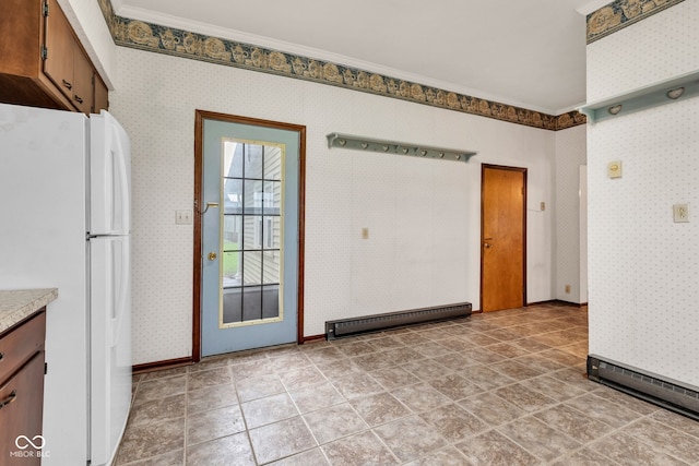 1437 S 725 W, Tipton, IN 46072 - unfurnished dining area featuring a baseboard heating unit, wallpapered walls, baseboards, and ornamental molding