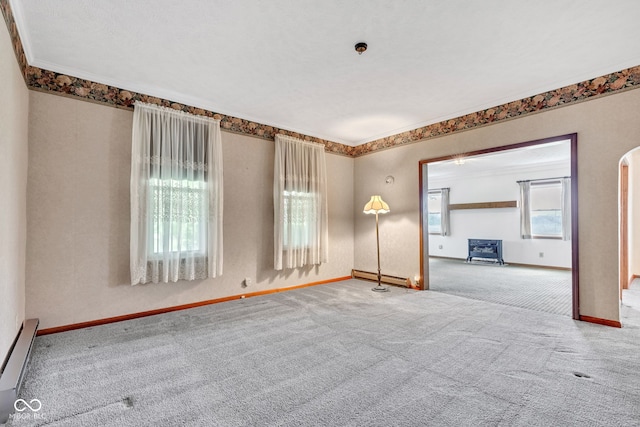 1437 S 725 W, Tipton, IN 46072 - carpeted empty room with baseboard heating, baseboards, and arched walkways
