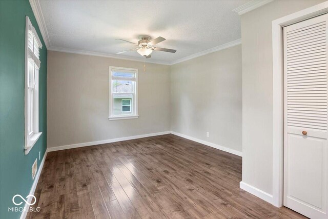 953 W Clinton St, Danville, IN 46122 - empty room with a ceiling fan, wood finished floors, baseboards, and crown molding