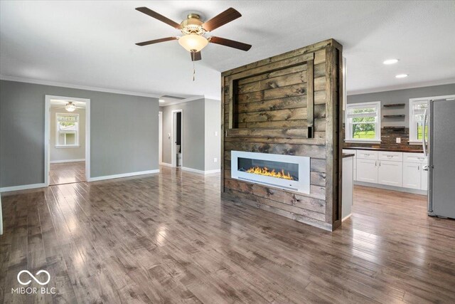 953 W Clinton St, Danville, IN 46122 - unfurnished living room featuring ceiling fan, ornamental molding, a large fireplace, baseboards, and recessed lighting