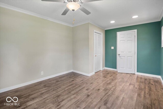 953 W Clinton St, Danville, IN 46122 - unfurnished room with baseboards, a ceiling fan, wood finished floors, recessed lighting, and crown molding