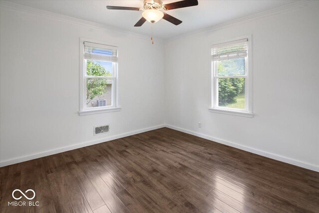 953 W Clinton St, Danville, IN 46122 - empty room with dark wood finished floors, ornamental molding, ceiling fan, and baseboards