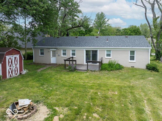 953 W Clinton St, Danville, IN 46122 - back of property with brick siding, a yard, a shingled roof, and a patio