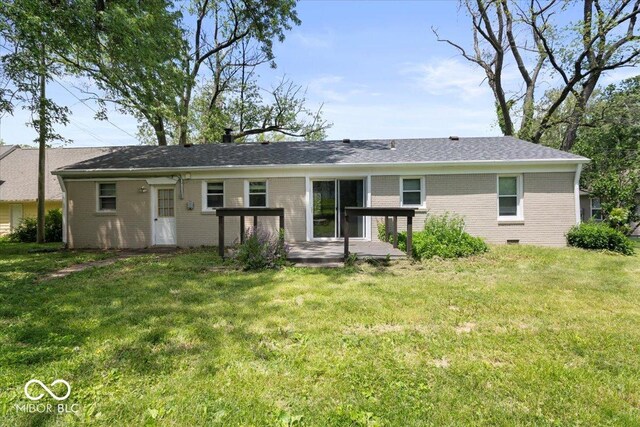 953 W Clinton St, Danville, IN 46122 - back of property featuring brick siding, a lawn, a patio, and roof with shingles