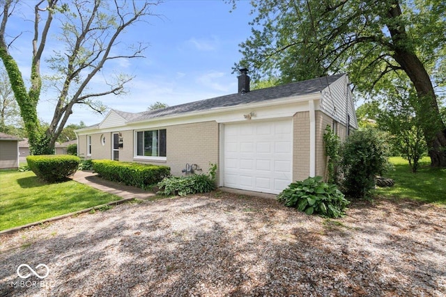 953 W Clinton St, Danville, IN 46122 - view of front facade with brick siding, a chimney, driveway, an attached garage, and a front lawn