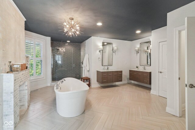 1616 N Delaware St, Indianapolis, IN 46202 - bathroom featuring a stall shower, a chandelier, baseboards, two vanities, and recessed lighting