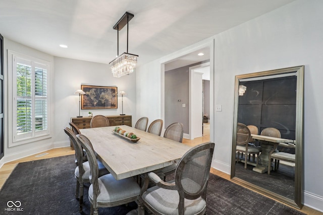 1616 N Delaware St, Indianapolis, IN 46202 - dining room with wood finished floors, baseboards, a chandelier, and recessed lighting