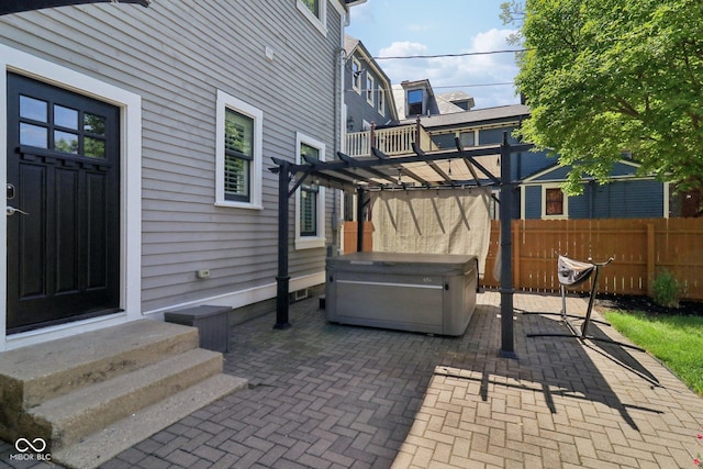 1616 N Delaware St, Indianapolis, IN 46202 - view of patio / terrace with a hot tub, entry steps, and fence