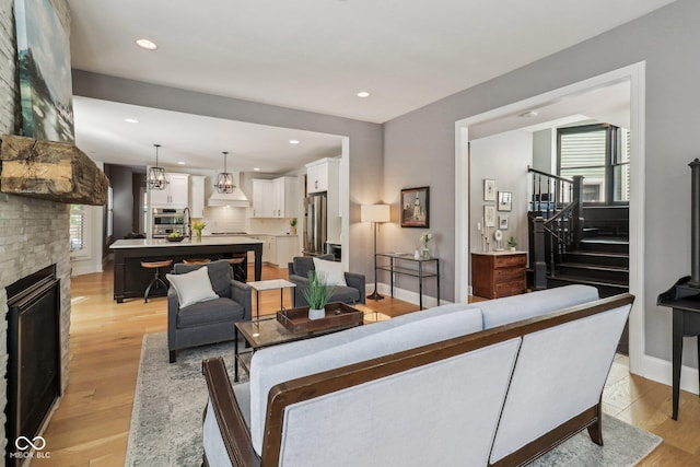 1616 N Delaware St, Indianapolis, IN 46202 - living room with light wood-style floors, stairs, recessed lighting, a fireplace, and baseboards