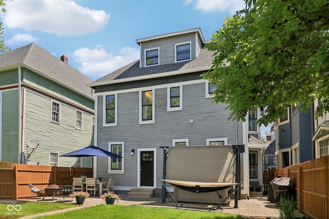 1616 N Delaware St, Indianapolis, IN 46202 - back of property with a fenced backyard, entry steps, a patio, and roof with shingles