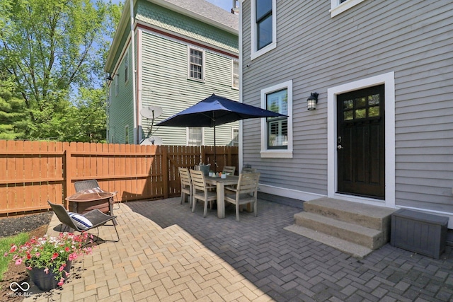 1616 N Delaware St, Indianapolis, IN 46202 - view of patio featuring an outdoor fire pit, fence, entry steps, and outdoor dining space