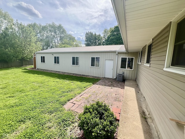 back of property featuring a patio, metal roof, and cooling unit