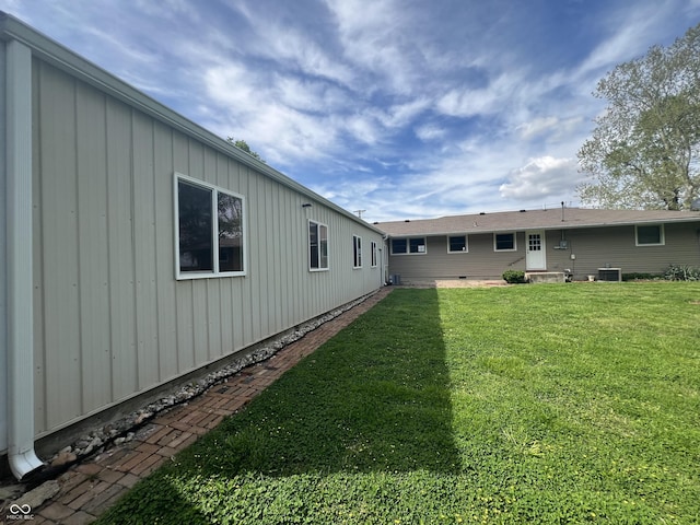 view of grassy yard with central AC unit