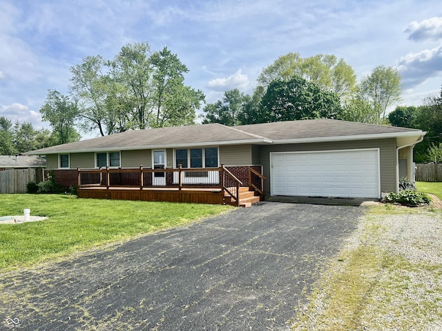 ranch-style home featuring a garage, asphalt driveway, and a wooden deck