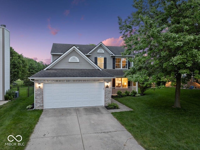 5041 Millwright Ct, Indianapolis, IN 46254 - traditional-style home featuring concrete driveway, brick siding, an attached garage, covered porch, and a shingled roof