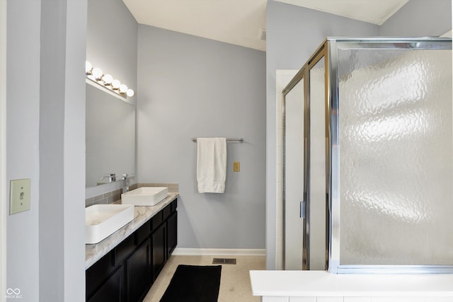 5041 Millwright Ct, Indianapolis, IN 46254 - bathroom with a stall shower, baseboards, and double vanity