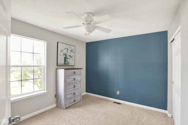 5041 Millwright Ct, Indianapolis, IN 46254 - bedroom featuring a closet, light colored carpet, baseboards, and a ceiling fan