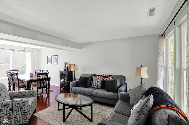 5041 Millwright Ct, Indianapolis, IN 46254 - living area with dark wood-style flooring, a chandelier, and baseboards