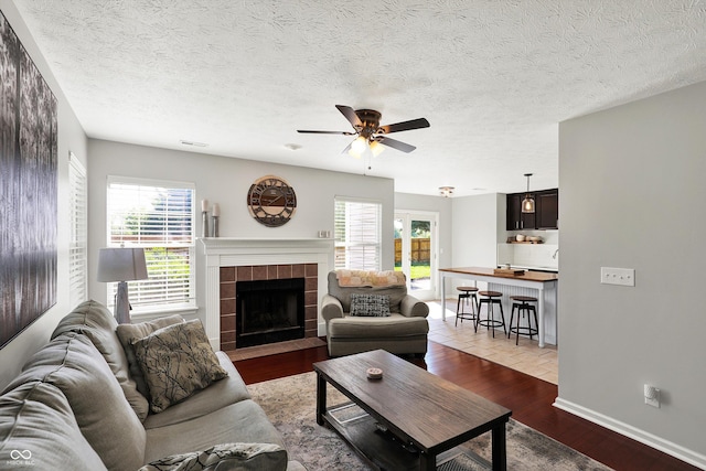 5041 Millwright Ct, Indianapolis, IN 46254 - living area with plenty of natural light, ceiling fan, wood finished floors, and a tiled fireplace