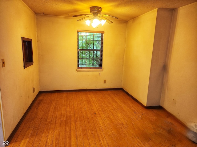 4336 Abby Creek Ln, Indianapolis, IN 46205 - empty room with a ceiling fan, wood finished floors, baseboards, and a textured ceiling