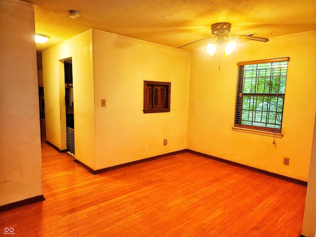 4336 Abby Creek Ln, Indianapolis, IN 46205 - empty room with a ceiling fan, wood finished floors, a smoke detector, a textured ceiling, and baseboards