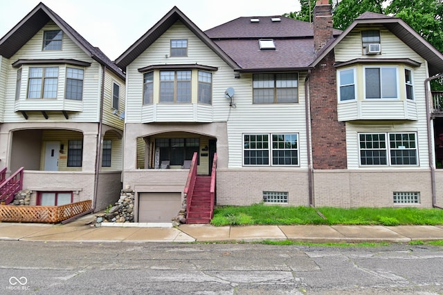 122 E 27th St, Indianapolis, IN 46205 - view of property with brick siding, a chimney, stairway, and an attached garage