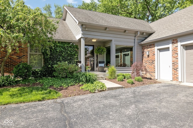 8330 Claridge Rd, Indianapolis, IN 46260 - view of front of property featuring brick siding, covered porch, and roof with shingles