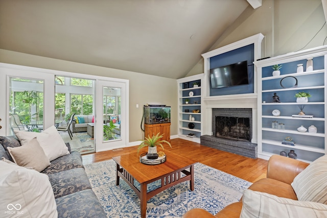 8330 Claridge Rd, Indianapolis, IN 46260 - living area with vaulted ceiling, wood finished floors, and a brick fireplace