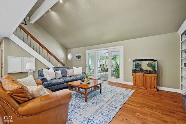 8330 Claridge Rd, Indianapolis, IN 46260 - living room featuring stairs, wood finished floors, baseboards, beam ceiling, and high vaulted ceiling