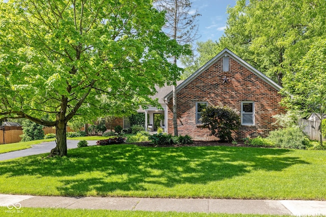8330 Claridge Rd, Indianapolis, IN 46260 - view of front facade featuring brick siding and a front lawn