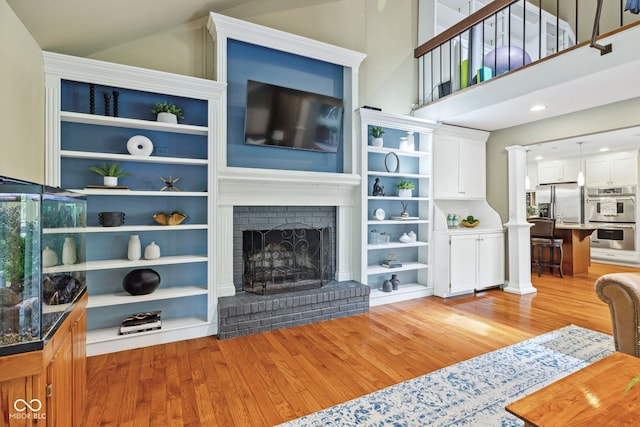 8330 Claridge Rd, Indianapolis, IN 46260 - living room featuring light wood-type flooring, a fireplace, and recessed lighting