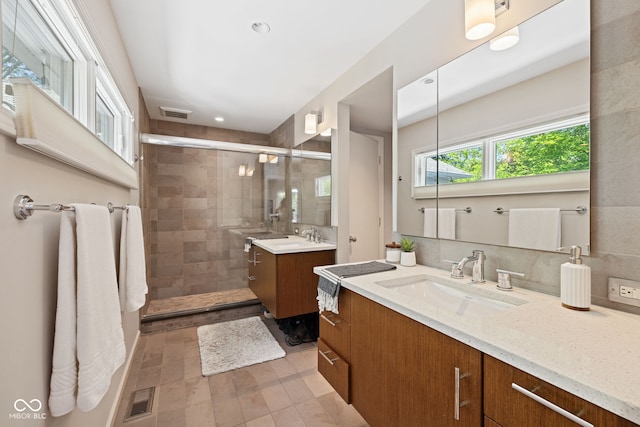 8330 Claridge Rd, Indianapolis, IN 46260 - bathroom with a stall shower, two vanities, and recessed lighting