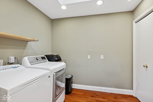 8330 Claridge Rd, Indianapolis, IN 46260 - laundry area with washer and clothes dryer, wood finished floors, baseboards, recessed lighting, and a skylight