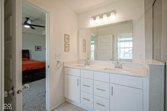 full bathroom with ceiling fan, double vanity, and ensuite bathroom