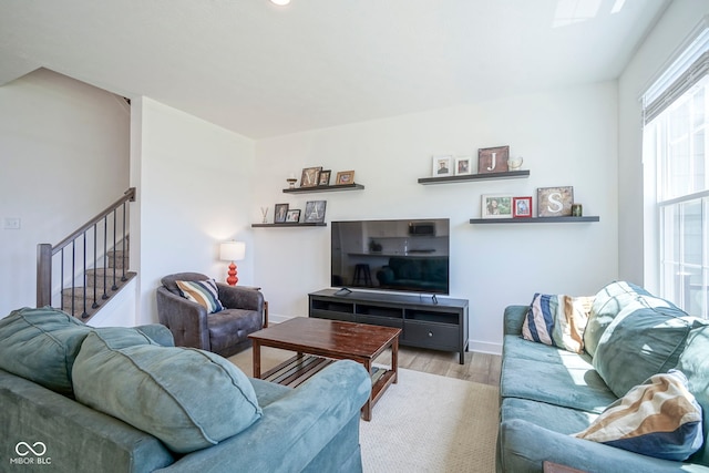 living room featuring wood finished floors and stairway