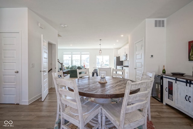 dining room featuring wood finished floors and recessed lighting