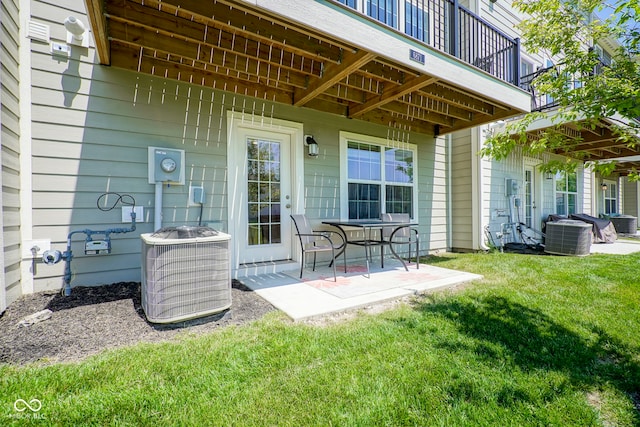 view of patio featuring central air condition unit and a balcony