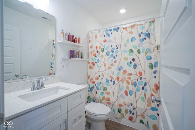 full bath featuring toilet, vanity, and shower / tub combo
