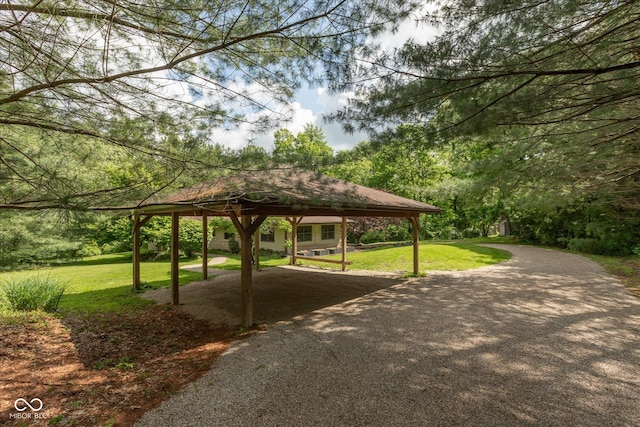 view of property's community with a gazebo, a yard, and a detached carport