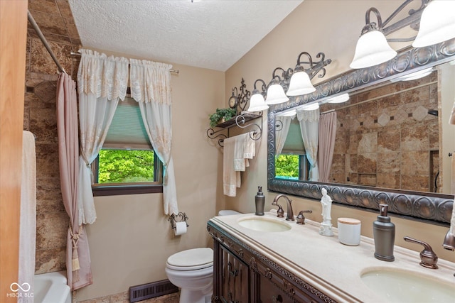 bathroom with toilet, a textured ceiling, double vanity, and shower / tub combo with curtain