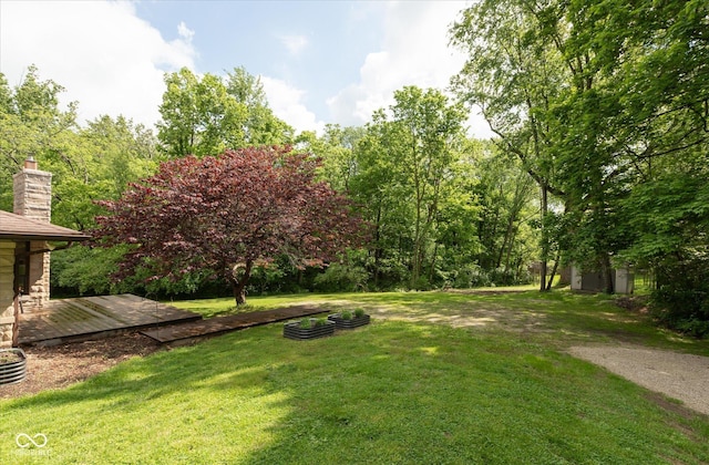 view of green lawn with a deck