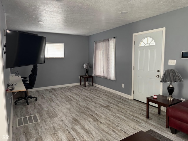322 S Rural St, Indianapolis, IN 46201 - entryway featuring a textured ceiling, wood finished floors, and baseboards