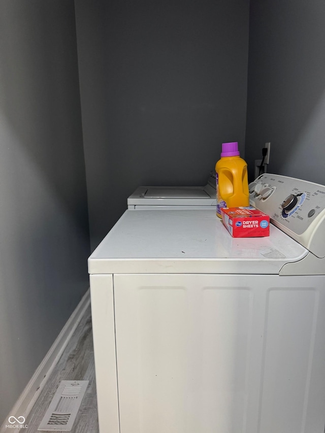 322 S Rural St, Indianapolis, IN 46201 - laundry area featuring washing machine and dryer, light wood-style flooring, and baseboards