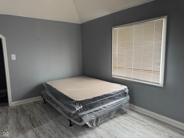 322 S Rural St, Indianapolis, IN 46201 - bedroom featuring wood finished floors, vaulted ceiling, and baseboards