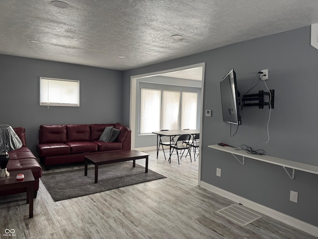 322 S Rural St, Indianapolis, IN 46201 - living area featuring a textured ceiling, wood finished floors, and baseboards