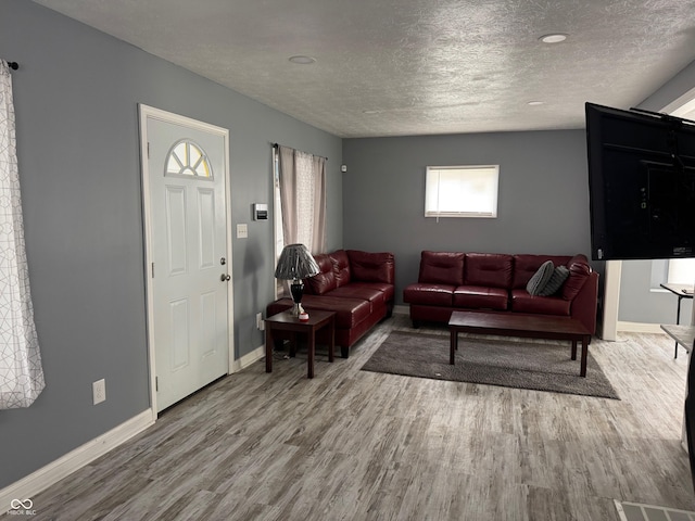 322 S Rural St, Indianapolis, IN 46201 - living area featuring wood finished floors, a textured ceiling, and baseboards