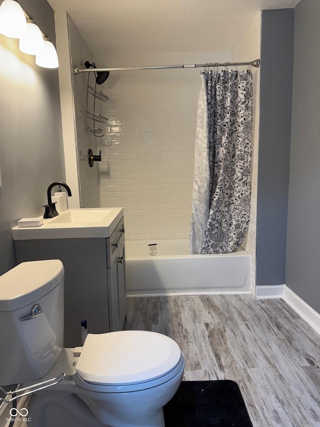 322 S Rural St, Indianapolis, IN 46201 - full bathroom with wood finished floors, toilet, shower / tub combo, and vanity