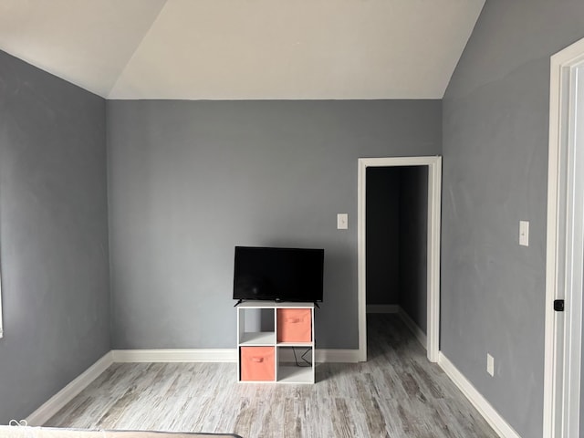 322 S Rural St, Indianapolis, IN 46201 - unfurnished bedroom with lofted ceiling, light wood finished floors, and baseboards